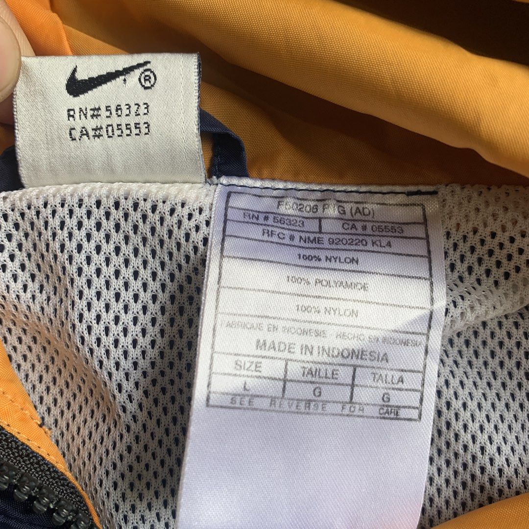 Vintage Nike Navy Blue Orange Windbreaker Jacket (Category: Coats, Jackets and Outerwear) located in Manila. Submitted by xumiiyea (Listing ID 1469583797, Image 3). Description: Nike 1990s vintage retro sportswear windbreaker navy blue size large 100% nylon made in Indonesia Full zip dual front pockets adjustable drawstring hood Excellent vintage condition.