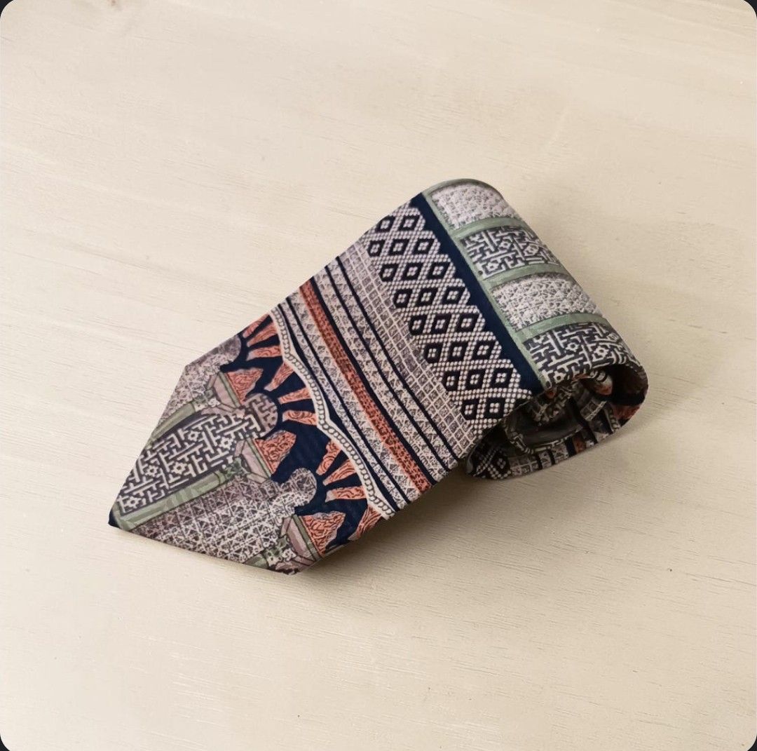 Vintage Oleg Cassini 100% Silk Tie w/ Geometric Pattern (Category: Ties) located in Quezon City. Submitted by happyvintage49 (Listing ID 1469732614, Image 1). Description: 📍Decluttering, NOT ukay - Design: Unique multi-pattern necktie with geometric and traditional motifs - Material: 100% pure silk - Width: Approximately 3.75 inches at the widest point - Color: blue, green, terracotta, and cream color blocking - Style: Great statement piece - Co