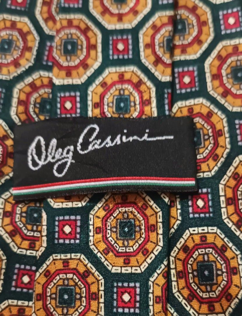 Vintage Oleg Cassini 100% Silk Tie w/ Geometric Pattern (Category: Ties) located in Quezon City. Submitted by happyvintage49 (Listing ID 1469733626, Image 3). Description: 📍Decluttering, NOT ukay - Brand: Vintage Oleg Cassini - Material: 100% silk - Design: Dark green background with gold, rust red, and white geometric octagon and medallion patterns - Width: Approximately 3.75 inches at the widest point - Style: Classic luxury menswear - Conditi