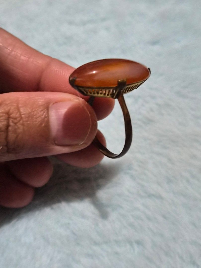Vintage Orange Carnelian Stone Ring Brass Setting size 8 (Category: Rings) located in Mandaue City. Submitted by chuchi152615 (Listing ID 1469686278, Image 2). Description: - Vintage statement ring with a striking large oval orange carnelian gemstone - Detailed brass basket setting featuring unique vertical slat cutouts around the stone - Slim, elegant gold-toned band for a comfortable fit - Warm reddish-orange color with natural stone variations