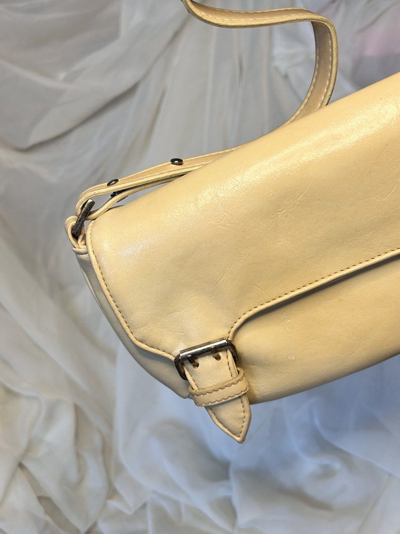 VINTAGE PASTEEL YELLOW BAGUETTE SHOULDER BAG (Category: Shoulder Bags) located in Baguio. Submitted by chmlnstudios (Listing ID 1469668119, Image 2). Description: VINTAGE PASTEEL YELLOW BAGUETTE SHOULDER BAG CODE: C11-B04 A chic Y2K baguette bag in a buttery pastel yellow hue. Featuring a curved flap silhouette with decorative buckle details and an adjustable strap with gunmetal hardware, making it a sweet pop of color for any minimalist or vinta