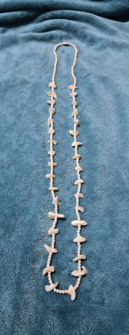 Vintage pearl and shell beaded necklace (Category: Necklaces) located in Mandaue City. Submitted by chuchi152615 (Listing ID 1469687677, Image 1). Description: - Length: Long 35-inch total length, easy to slip over the head - Materials: White pearl-like seed beads with scattered iridescent shell pieces and mother-of-pearl stations - Closure: Secure metallic silver-tone barrel clasp - Comfort: Lightweight design, comfortable for everyday wear - St