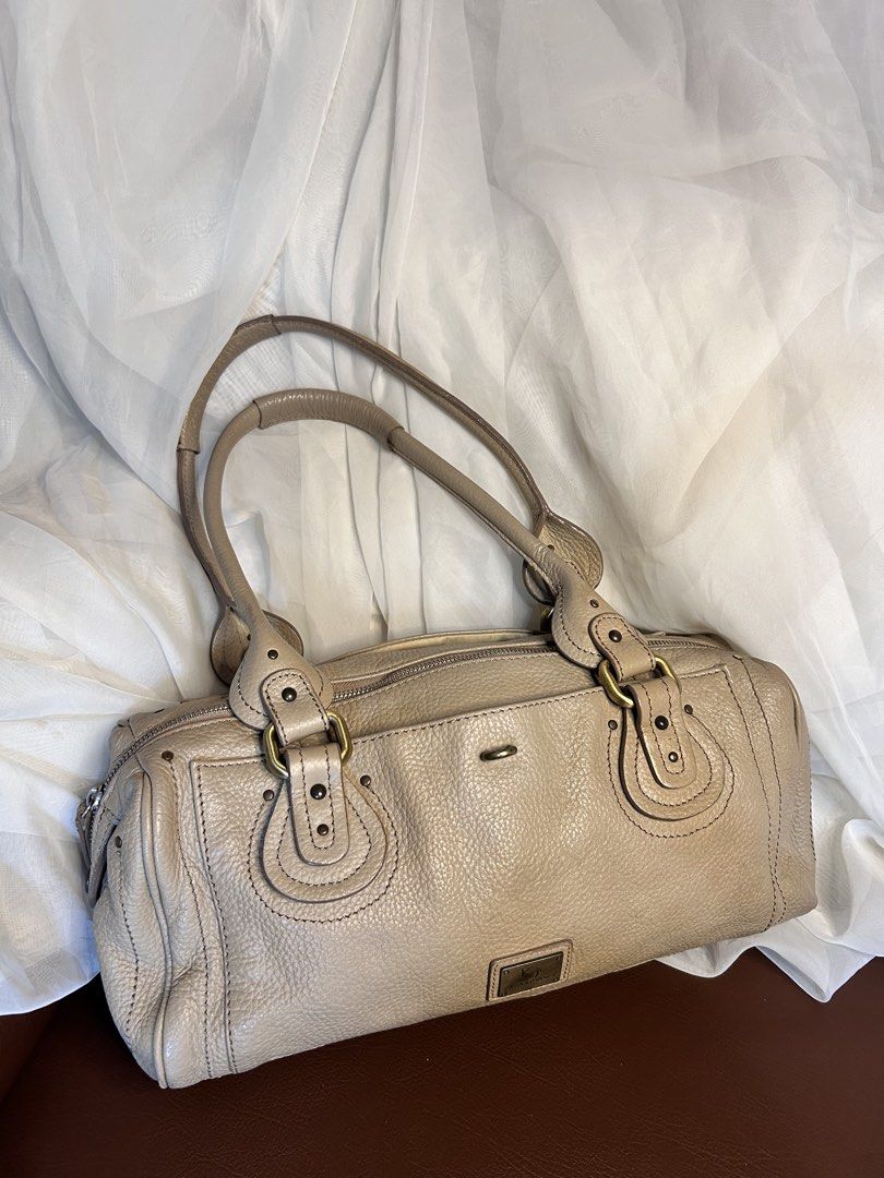 VINTAGE SLOUCHY LEATHER SHOULDER BAG (Category: Shoulder Bags) located in Baguio. Submitted by chmlnstudios (Listing ID 1469664267, Image 1). Description: VINTAGE SLOUCHY LEATHER SHOULDER BAG / BOWLING BAG CODE: C11-B02 A spacious, Y2K-inspired slouchy shoulder bag in a versatile beige / warm nude shade. Crafted from pebbled leather with antique brass hardware accents and Chloe-style padded handle details, making it an effortless daily statement 