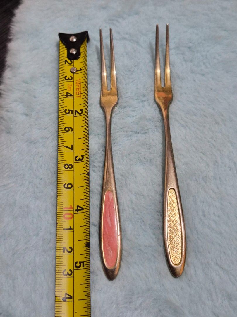 Vintage Two-Prong Fork Cocktail Fruit Fork Set (Category: Dinnerware & Cutlery) located in Mandaue City. Submitted by chuchi152615 (Listing ID 1469702783, Image 2). Description: - Set of 2 small two-prong forks, approx. 4.5 inches long - Solid metal construction for durability - Unique designs: 1 textured gold-tone handle and 1 swirled pink enamel inlay - Ideal for appetizers, fruits, desserts, and parties - Add a charming touch to your next gath
