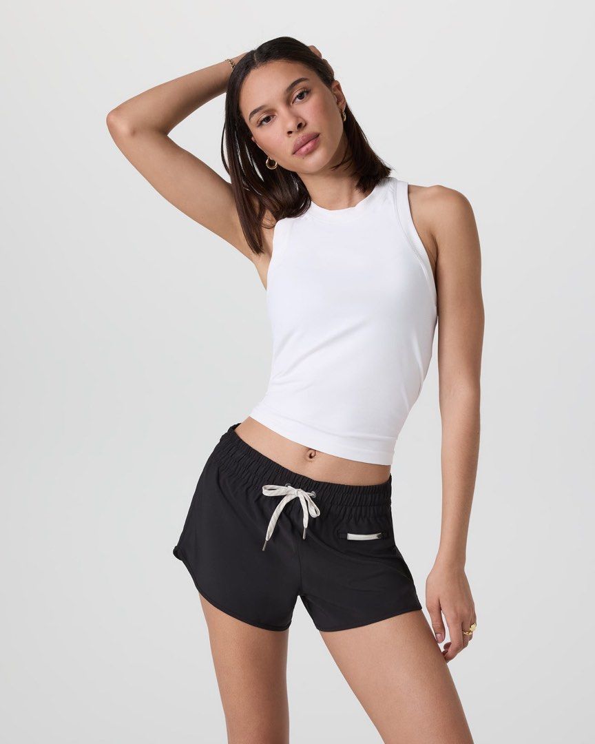 Vuori Seamless Tank (Category: Sleeveless) located in Makati City. Submitted by thevault88 (Listing ID 1469692377, Image 1). Description: - Brand: Vuori - Color: White - Style: Active seamless tank top with racerback - Features: Breathable perforated side panels and subtle embossed logo on the bottom left hem - Versatility: Ideal for workouts, gym sessions.