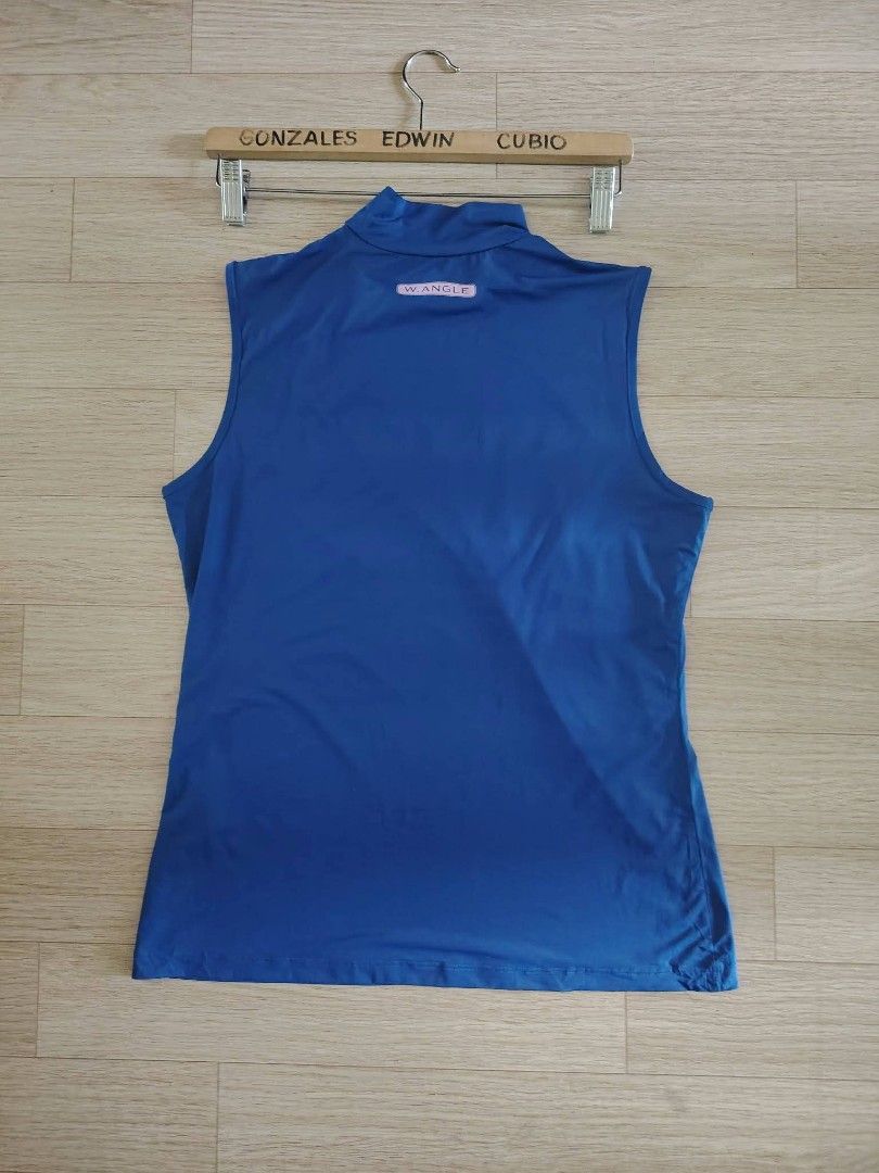 w.angle Blue Sleeveless Golf Top(W18xL (Category: Sleeveless) located in Nasipit. Submitted by edwingonzales498-69377 (Listing ID 1469578761, Image 3). Description: - Brand/Model: W.ANGLE sleeveless golf top - Color: Royal blue with pink script logo and collar branding - Details: Small pink W.ANGLE tag at the back nape - Fabric: Lightweight and stretchy, ideal for golf - Measurements: Width 18 inches x Length 24 inches.