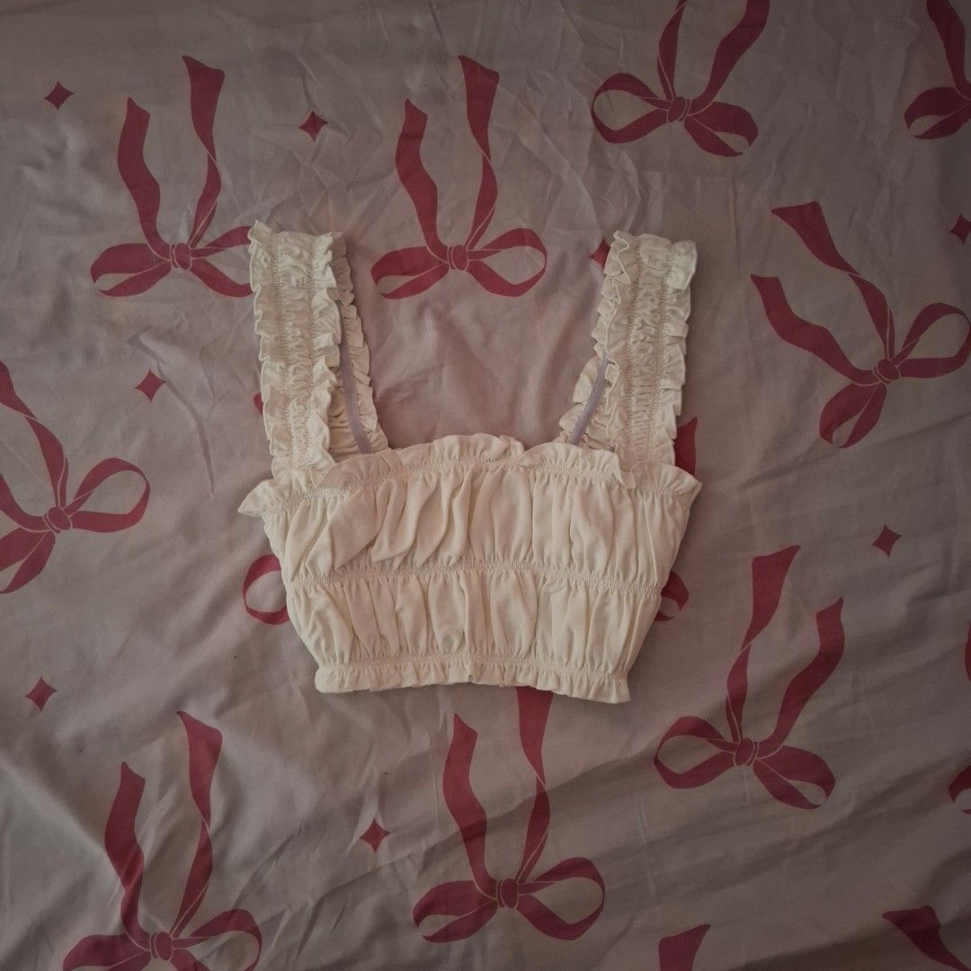 Westfade Orange Ruffle Crop Top (Category: Sleeveless) located in Dasmarinas. Submitted by luzella (Listing ID 1469726519, Image 1). Description: 100 EACH TOP - Condition: Brand new with tag still attached - Color: Vibrant orange - Design: Ruffle straps and gathered body - Fabric: Soft and comfortable - Versatility: Great basic piece, easy to match with high-waisted denim or skirts.