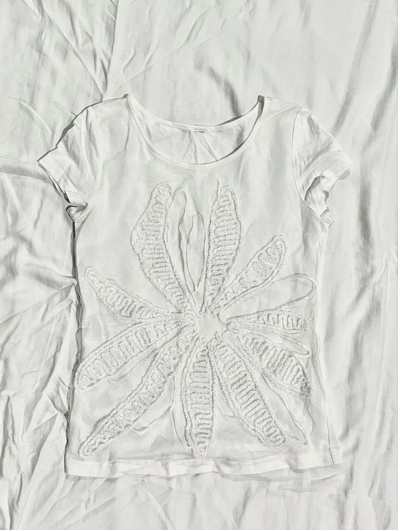 White Blouse with Floral Embroidery (Category: Shirts) located in Muntinlupa City. Submitted by _gudstuff (Listing ID 1469583311, Image 1). Description: - Color: White - Fit: Casual fit with a flattering scoop neckline - Design: Eye-catching large textured flower print on the front - Material: Soft, breathable cotton for all-day comfort - Style: Versatile basic, great for easy everyday outfits - XS to S.