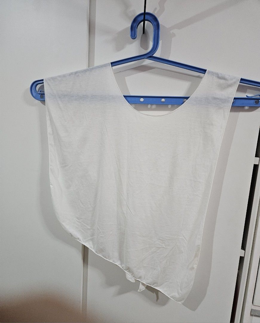 White Cape/Poncho asymmetrical sleeveless top (Category: Others Tops) located in Caloocan City. Submitted by rm.diaz (Listing ID 1469680276, Image 3). Description: - Color: Plain white - Style: Cape/Poncho-Style Top -Sleeveless with asymmetrical hem - Rounded boat neckline, open draped construction and a sharp slanted diagonal hemline - Fabric: Lightweight and breathable, ideal for covering a swimsuit .
