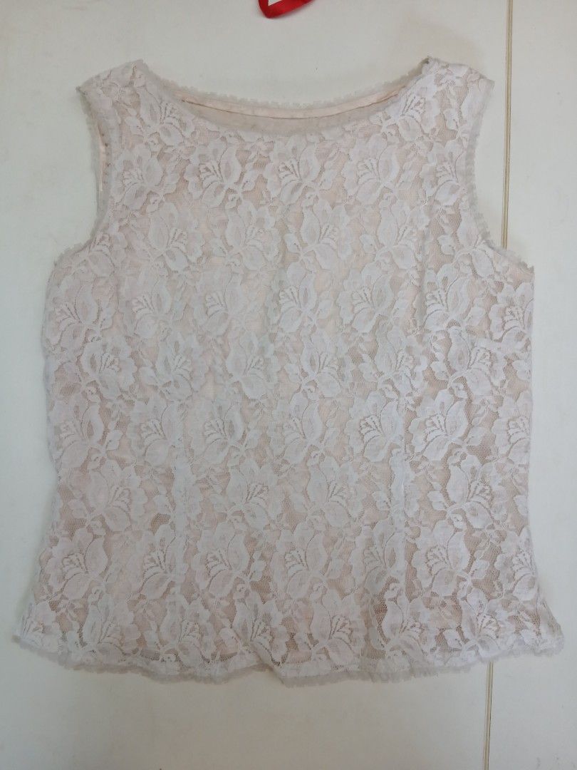 White lace sleeveless top with nude lining (Category: Sleeveless) located in Cainta. Submitted by chickennuggirl (Listing ID 1469579913, Image 1). Description: - Color: White with nude lining - Material: Soft, lightweight floral lace - Design: Sleeveless with a scoop neckline - Versatility: Perfect for warmer days, layering, or wearing on its own - Styling: Easily pairs with both skirts and jeans.