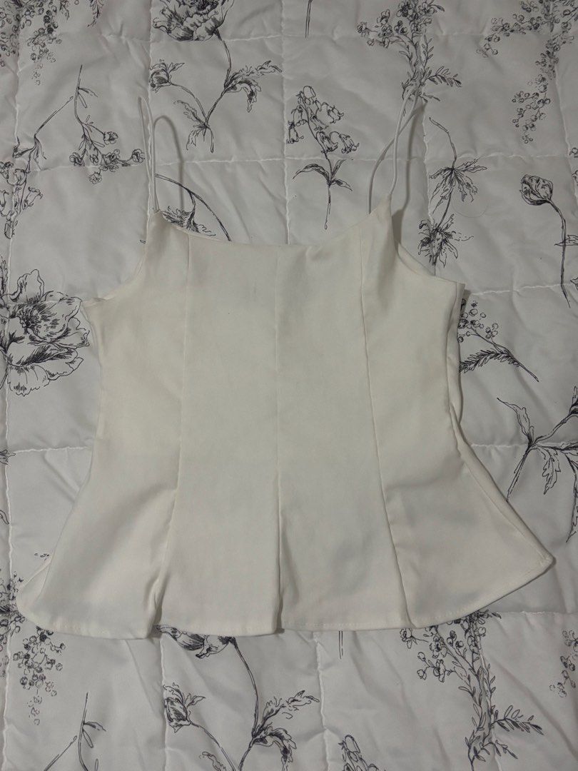 White peplum camisole top with spaghetti straps (Category: Sleeveless) located in Cainta. Submitted by thriftedbymimi_ (Listing ID 1469675452, Image 1). Description: not my style price is negotiable, bundle deals available. send a message MOP: Gcash/Maribank/Gotyme/Bank Transfer MOD: lalamove .