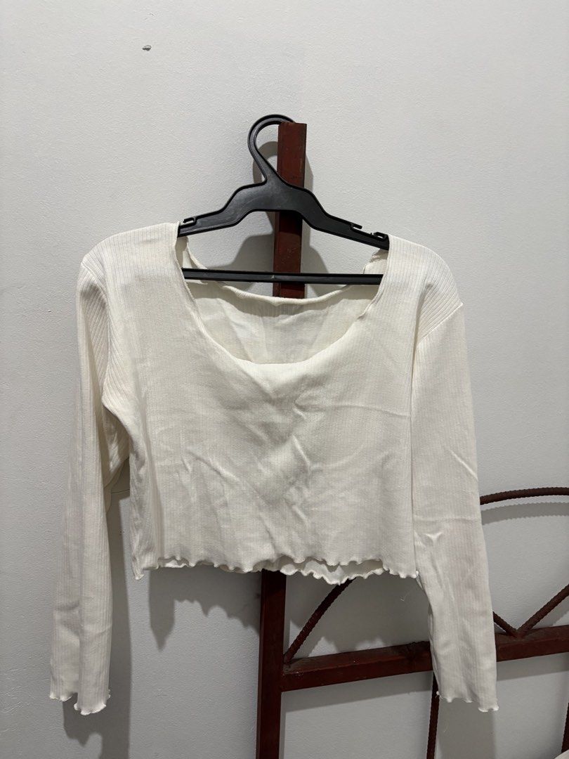 White ribbed long sleeve crop top lettuce hem (Category: Longsleeves) located in Manila. Submitted by airryy.preloved (Listing ID 1469716783, Image 1). Description: - Color: White - Style: Long sleeve crop top - Material: Ribbed knit - Neckline: Low square neck - Details: Lettuce hem finish on cuffs and bottom edge - Fit: Great for casual daily wear, easy to pair with high-waisted jeans or skirts.