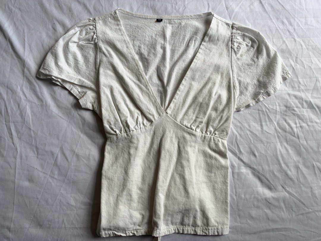White V-neck Short Sleeve Blouse (Category: Blouses) located in Quezon City. Submitted by grapejuiceblue2 (Listing ID 1469595184, Image 1). Description: 🏷️TikTok Shop (size M on tag!) - worn - rfs: decluttering - mop: gcash only - mod: lalamove/j&t - price + sf.