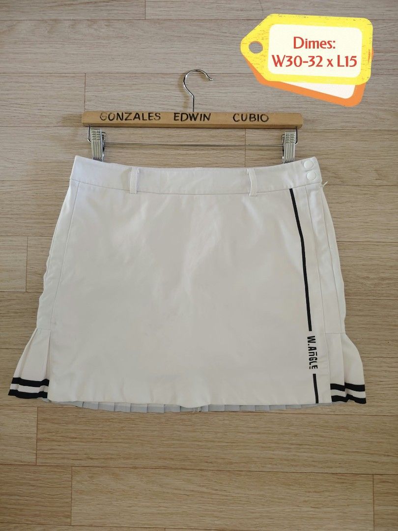 Wide Angle White Golf Skirt(W30-32 x L15) (Category: Skirts) located in Nasipit. Submitted by edwingonzales498-69377 (Listing ID 1469578696, Image 2). Description: - Brand: Wide Angle - Color: White with black stripe details - Style: Pleated hem golf skort with built-in shorts for extra coverage - Pockets: One vertical side pocket and back pockets with 'BIRDIE! W.ANGLE' branding - Waist: Measures approx. 73-79cm - Condition: Great sporty piece fo