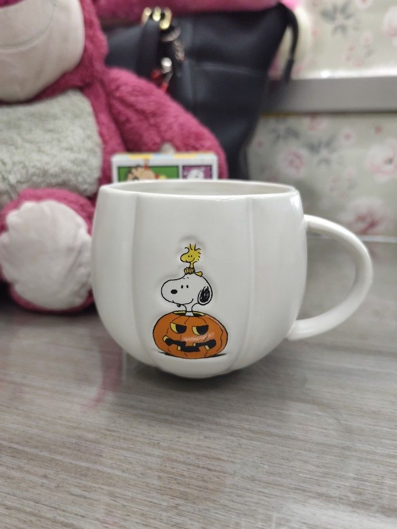 Williams Sonoma Peanuts Snoopy Pumpkin Mug (Category: Coffee & Tea Tableware) located in Iloilo. Submitted by elenmenope (Listing ID 1469595155, Image 1). Description: - Authentic Williams Sonoma Peanuts Halloween ceramic mug - Adorable 3D design of Snoopy on a jack-o'-lantern holding Woodstock - Classic white pumpkin shape with charming vertical ridges - Microwave and dishwasher safe for easy everyday use - Perfect gift for coffee, tea, and hot 