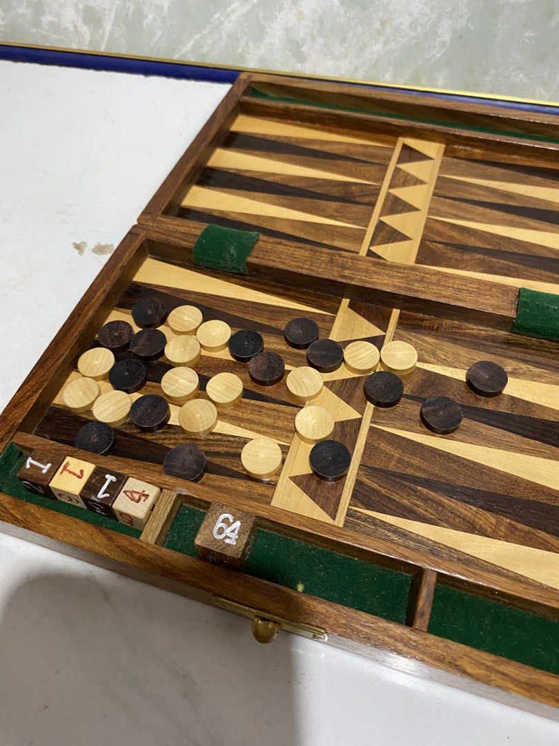 Wooden Backgammon Set Board Game with Dice and Chips (Category: Board Games & Puzzles) located in Calamba. Submitted by chebvintagedepot (Listing ID 1469664700, Image 3). Description: (B18-03) “Wooden folding backgammon board with decorative wood inlay and a traditional design. The board folds for storage and transport, making it suitable for home use or travel. Please note: Missing one white circular checker piece. The set is incomplete. (14/15 