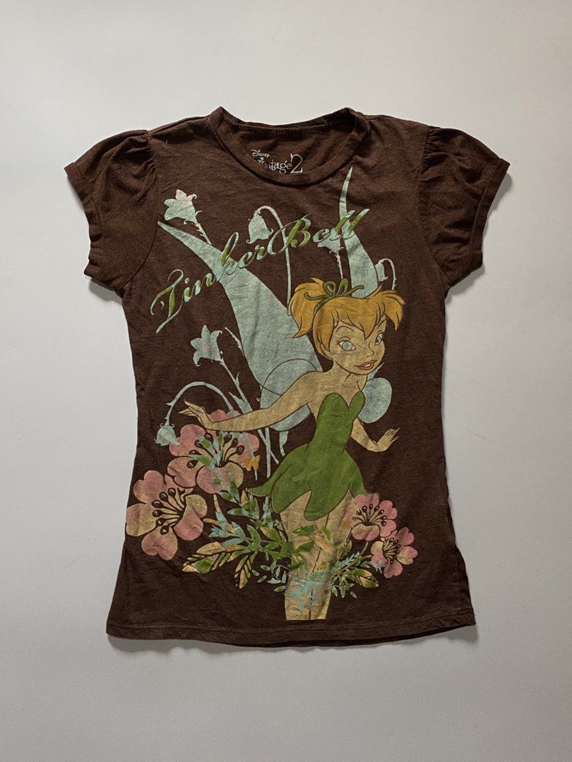 Y2k Disney Tinker Bell Puff Sleeve Tee (Category: Shirts) located in Manila. Submitted by lexia_swrdrbfinds (Listing ID 1469707864, Image 1). Description: ⋆ 𐙚 ̊ Y2k Disney Tinker Bell Puff Sleeve Tee 🌸 𝓈𝒾𝓏ℯ ℴ𝓃 𝓉𝒶𝑔: medium 🩷 𝓁ℯ𝓃𝑔𝓉𝒽: 20 🌷 𝓌𝒾𝒹𝓉𝒽: 12 🎀 𝒸ℴ𝓃𝒹𝒾𝓉𝒾ℴ𝓃: 9.5/10 🫧 𝒻𝓁𝒶𝓌𝓈: natural print fading 𝓅𝓇𝒾𝒸ℯ: 299 ✦ 𝓅𝓁𝓊𝓈 𝓈𝒽𝒾𝓅𝓅𝒾𝓃𝑔 𝒻ℯℯ.