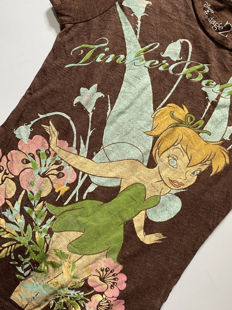 Y2k Disney Tinker Bell Puff Sleeve Tee (Category: Shirts) located in Manila. Submitted by lexia_swrdrbfinds (Listing ID 1469707864, Image 2). Description: ⋆ 𐙚 ̊ Y2k Disney Tinker Bell Puff Sleeve Tee 🌸 𝓈𝒾𝓏ℯ ℴ𝓃 𝓉𝒶𝑔: medium 🩷 𝓁ℯ𝓃𝑔𝓉𝒽: 20 🌷 𝓌𝒾𝒹𝓉𝒽: 12 🎀 𝒸ℴ𝓃𝒹𝒾𝓉𝒾ℴ𝓃: 9.5/10 🫧 𝒻𝓁𝒶𝓌𝓈: natural print fading 𝓅𝓇𝒾𝒸ℯ: 299 ✦ 𝓅𝓁𝓊𝓈 𝓈𝒽𝒾𝓅𝓅𝒾𝓃𝑔 𝒻ℯℯ.