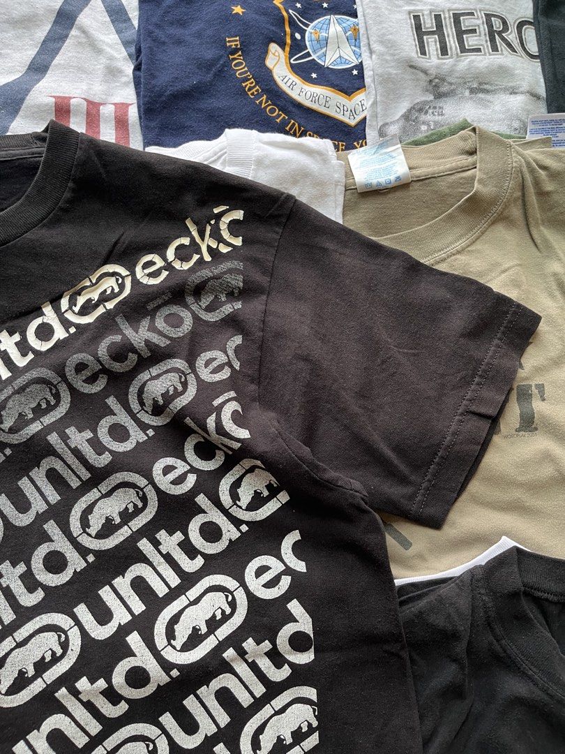 Y2K Ecko Unltd Black Graphic Tee with Rhino Logo (Category: Tshirts & Polo Shirts ) located in Baao. Submitted by plainclothesdept (Listing ID 1469706803, Image 2). Description: y2k ecko unltd logo spellout all over print width - 22 in. length - 28 in. no flaws - Brand: Ecko Unltd - Color: Black - Design: Diagonal repeat logo and iconic rhino graphics across the chest - Details: Crew neck, short sleeves, branded inner collar tag - Condition: Auth
