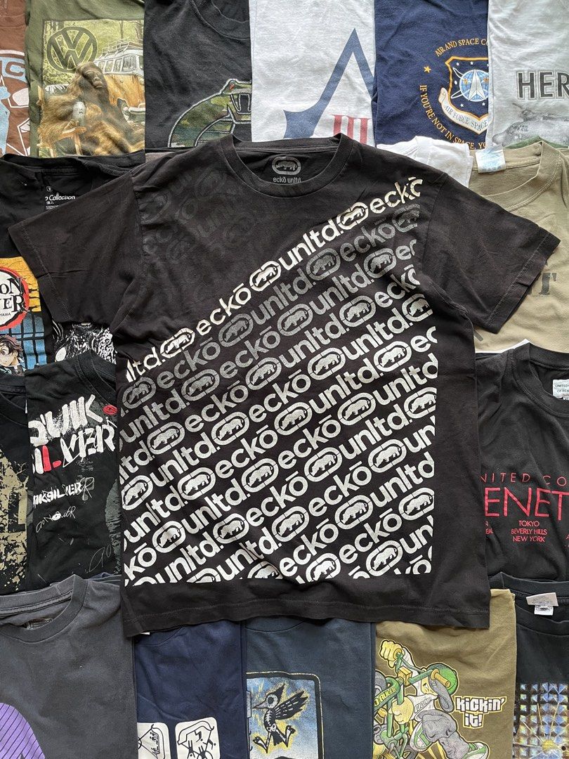 Y2K Ecko Unltd Black Graphic Tee with Rhino Logo (Category: Tshirts & Polo Shirts ) located in Baao. Submitted by plainclothesdept (Listing ID 1469706803, Image 1). Description: y2k ecko unltd logo spellout all over print width - 22 in. length - 28 in. no flaws - Brand: Ecko Unltd - Color: Black - Design: Diagonal repeat logo and iconic rhino graphics across the chest - Details: Crew neck, short sleeves, branded inner collar tag - Condition: Auth