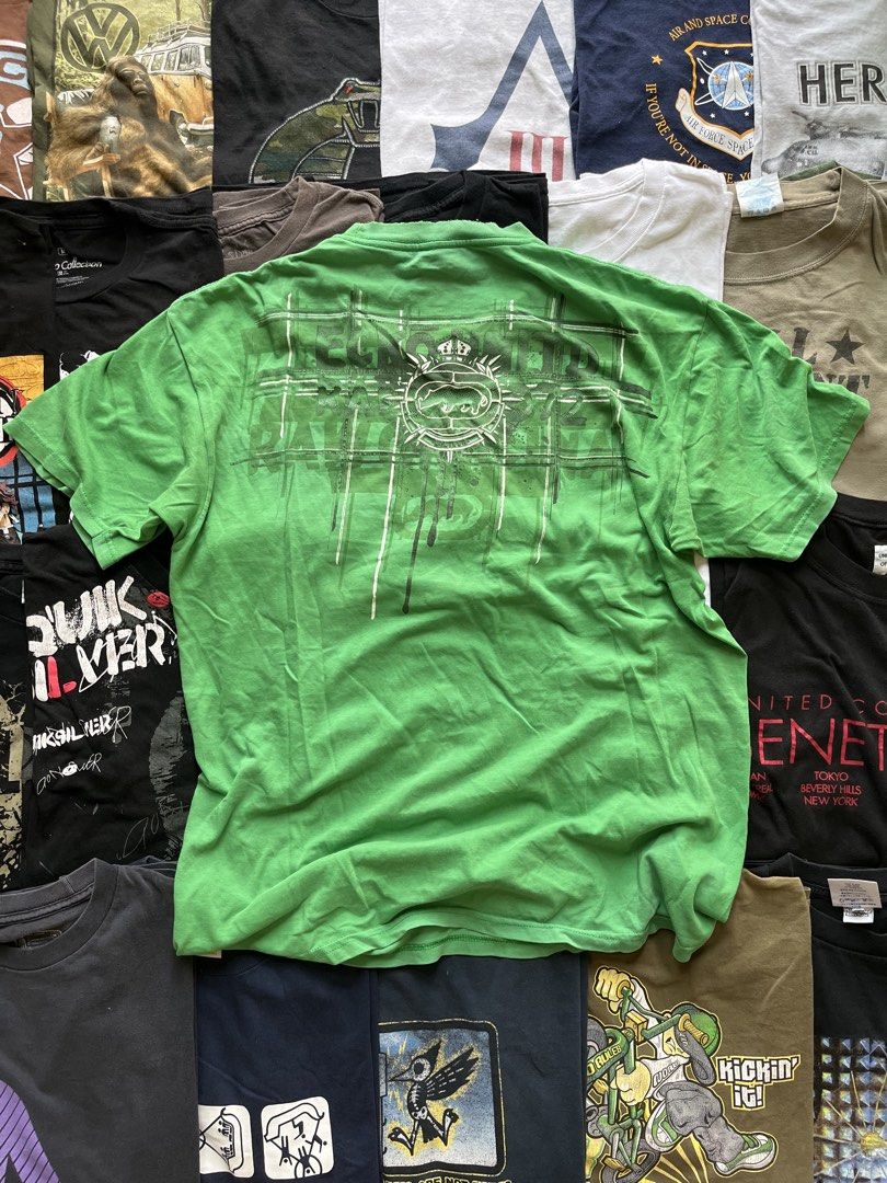 Y2K Ecko Unltd Green Graphic T-Shirt Large (Category: Tshirts & Polo Shirts ) located in Baao. Submitted by plainclothesdept (Listing ID 1469706765, Image 2). Description: y2k green ecko unltd big logo vertical spellout width - 22 in. length - 28 in. cracks on print, signs of wear (neckline) - Brand/Model: Ecko Unltd Tee - Color: Bright Green - Size: Large - Material: Standard Cotton - Design: Heavy front and back graphic print with classic rhino