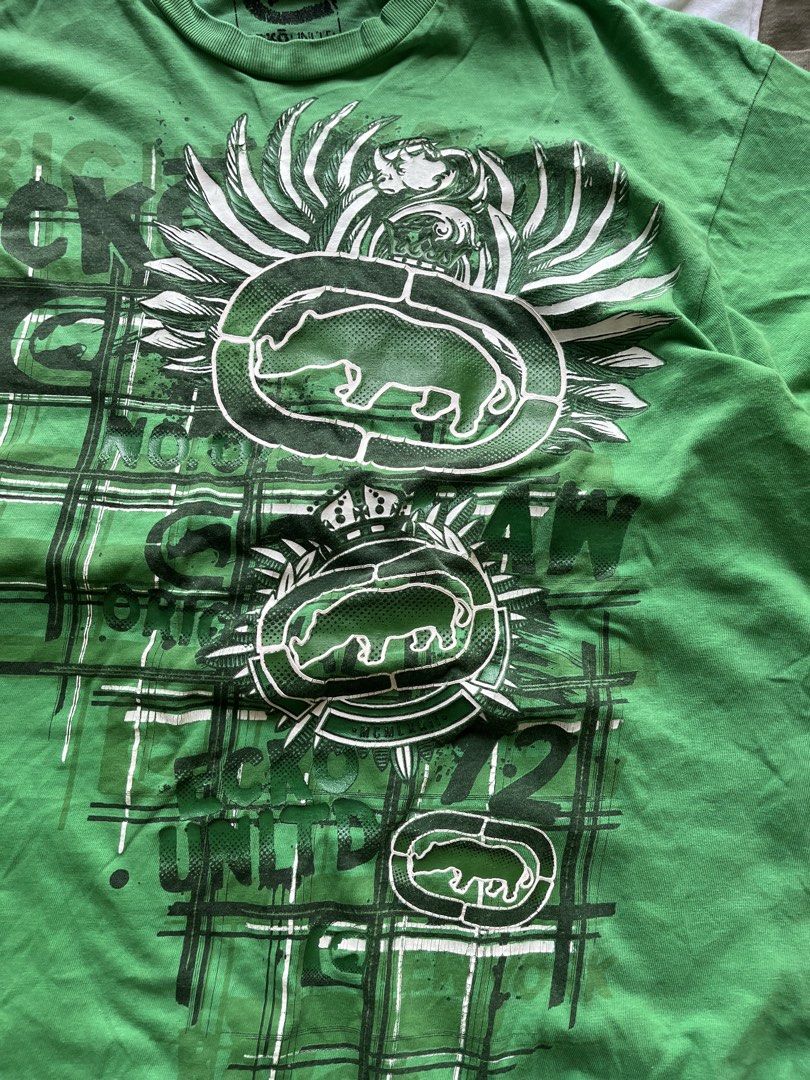 Y2K Ecko Unltd Green Graphic T-Shirt Large (Category: Tshirts & Polo Shirts ) located in Baao. Submitted by plainclothesdept (Listing ID 1469706765, Image 3). Description: y2k green ecko unltd big logo vertical spellout width - 22 in. length - 28 in. cracks on print, signs of wear (neckline) - Brand/Model: Ecko Unltd Tee - Color: Bright Green - Size: Large - Material: Standard Cotton - Design: Heavy front and back graphic print with classic rhino