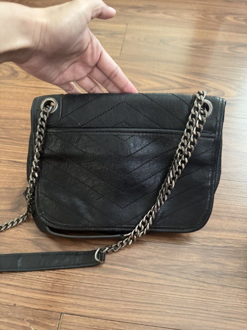 Y S L Niki (Category: Cross-body Bags) located in Rizal. Submitted by thrifty.mom (Listing ID 1469646826, Image 3). Description: - Brand: Saint Laurent - Material: Black crinkled leather with chevron quilting - Hardware: Dark hardware with signature YSL front monogram - Straps: Chain straps with leather shoulder guards and embossed logo - Capacity: Easily fits phone, keys, and wallet - perfect for daily use Thrift find item No guarantee no inclus