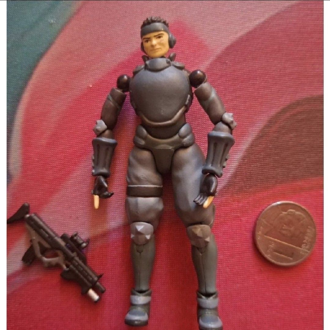 Yujin Appleseed Active Motion Model Kidu Action Figure (Category: Figurines & Statues) located in Arayat. Submitted by collectorboy143 (Listing ID 1469582107, Image 2). Description: Kidu action figure from the Appleseed Active Motion Model series by Yujin. Stands around 20 points of articulation. Grey armored suit with headset and rifle accessory included. Coin shown next to figure for scale reference only. Loose piece from capsule toy release..
