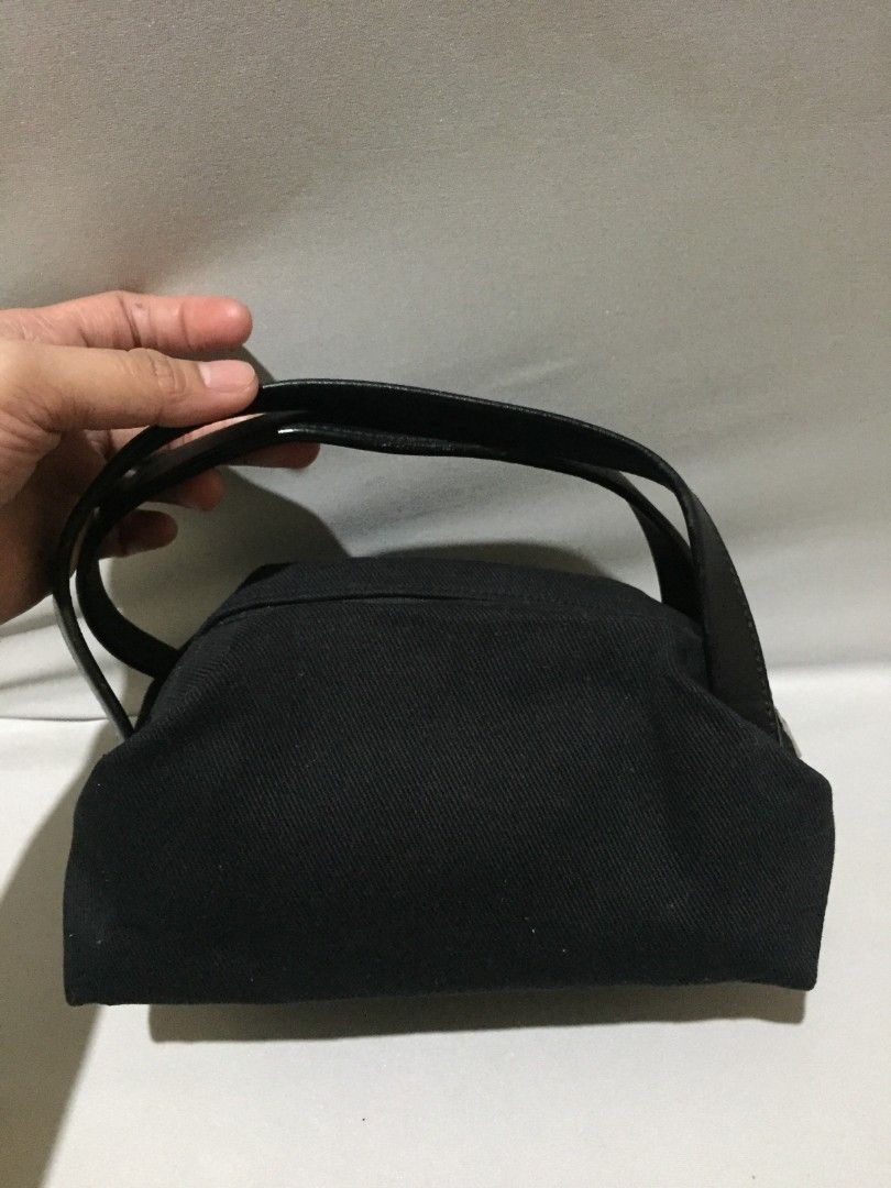 Yves Saint Laurent Rive Gauche (Category: Luxury Bags & Wallets) located in Bulacan. Submitted by assorted.items (Listing ID 1469706067, Image 2). Description: *The Midnight Pouch* A little piece of Paris, found in Japan. Black canvas, soft but structured. Gold embroidered logo in front — quiet, but everyone knows. - Top handle, leather — smooth with natural grain - Gold zipper pull, heavy & engraved - Satin lining, clean inside - Tag inside: riv