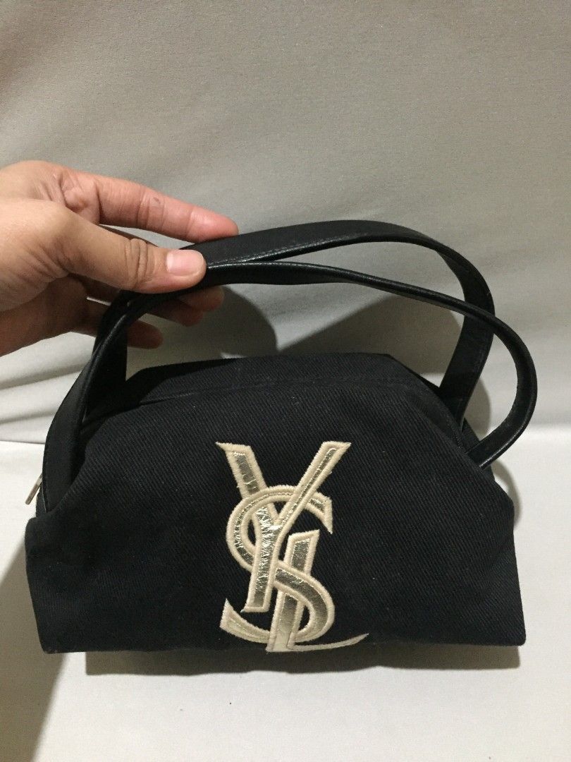 Yves Saint Laurent Rive Gauche (Category: Luxury Bags & Wallets) located in Bulacan. Submitted by assorted.items (Listing ID 1469706067, Image 1). Description: *The Midnight Pouch* A little piece of Paris, found in Japan. Black canvas, soft but structured. Gold embroidered logo in front — quiet, but everyone knows. - Top handle, leather — smooth with natural grain - Gold zipper pull, heavy & engraved - Satin lining, clean inside - Tag inside: riv