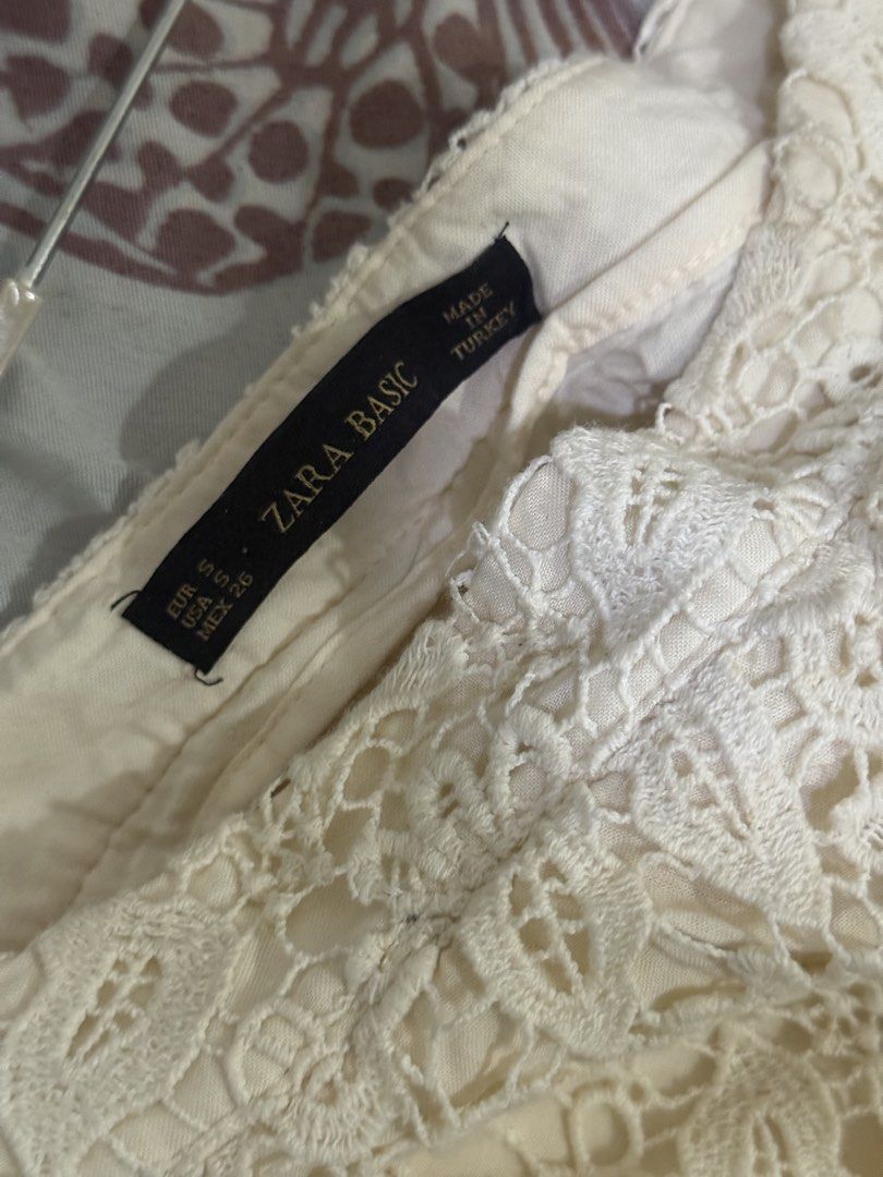Zara Basic White Lace Shorts Skort Size S (Category: Shorts) located in Cebu City. Submitted by hotchkisscebu (Listing ID 1469613352, Image 3). Description: - Brand: Zara Basic - Size: Small (EUR S, USA S, MEX 26) can fit until semi med - Color: White with cream inner lining - Design: Beautiful floral lace pattern with a front overlay for a skirt effect - Closure: Side zipper - Origin: Made in Turkey - Condition: Clean and ready to wear Overlappi