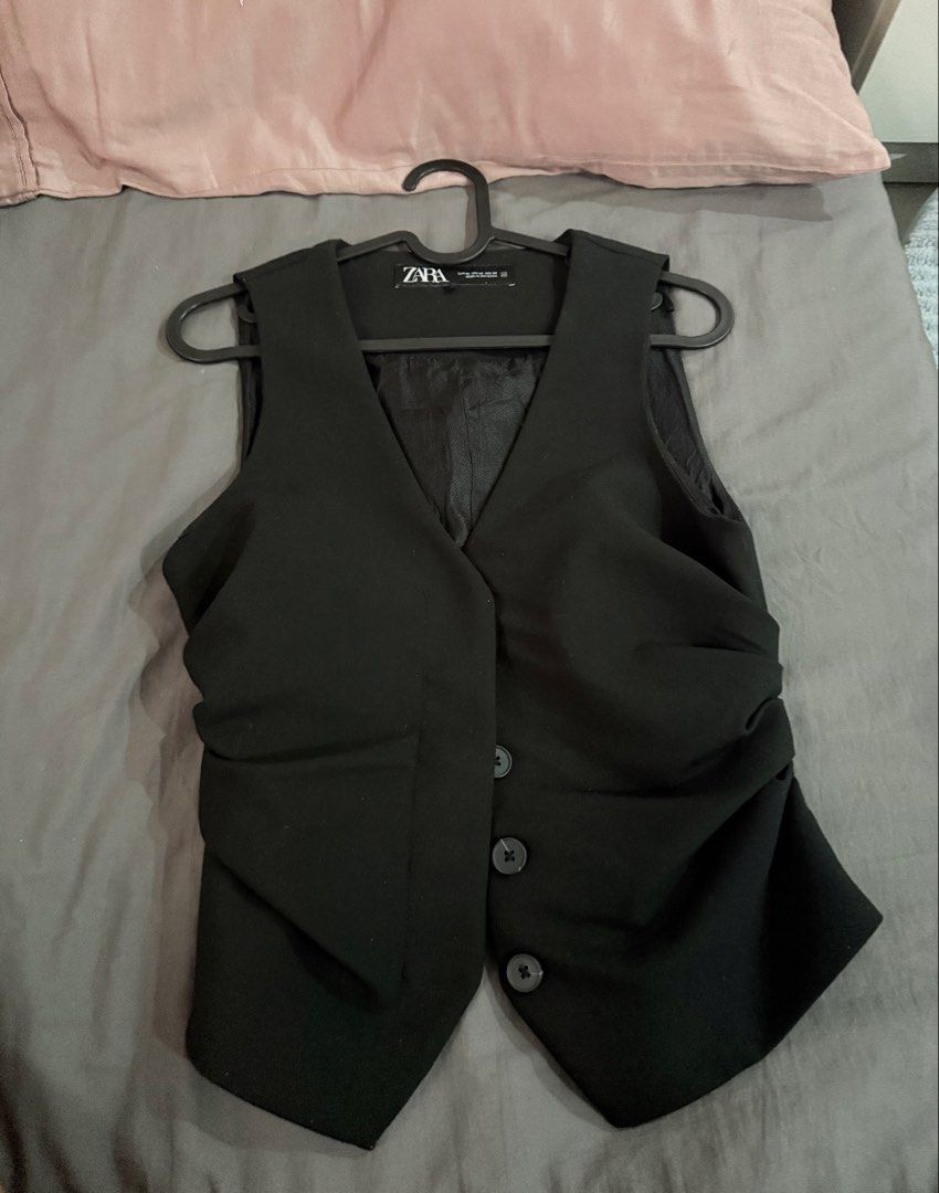 Zara Black Waistcoat Vest (Category: Sleeveless) located in Cavite. Submitted by momomochii (Listing ID 1469755088, Image 3). Description: - Brand: Zara - Size: EUR XS / US XS / MEX 24 - Color: Black - Style: Classic v-neck, front button closure, fitted cut with trendy side ruching - Condition: Excellent, worn a few times, clean and ready to wear - Versatility: Perfect for both office wear and casual outings.
