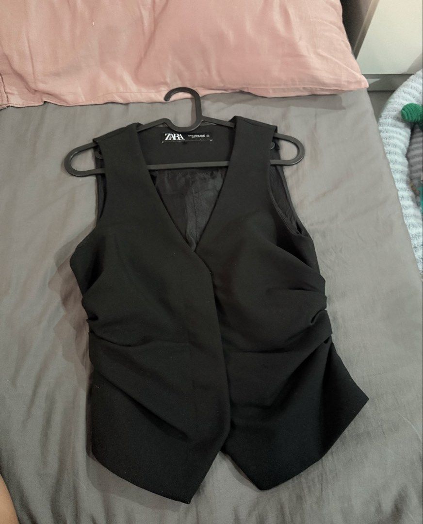 Zara Black Waistcoat Vest (Category: Sleeveless) located in Cavite. Submitted by momomochii (Listing ID 1469755088, Image 2). Description: - Brand: Zara - Size: EUR XS / US XS / MEX 24 - Color: Black - Style: Classic v-neck, front button closure, fitted cut with trendy side ruching - Condition: Excellent, worn a few times, clean and ready to wear - Versatility: Perfect for both office wear and casual outings.