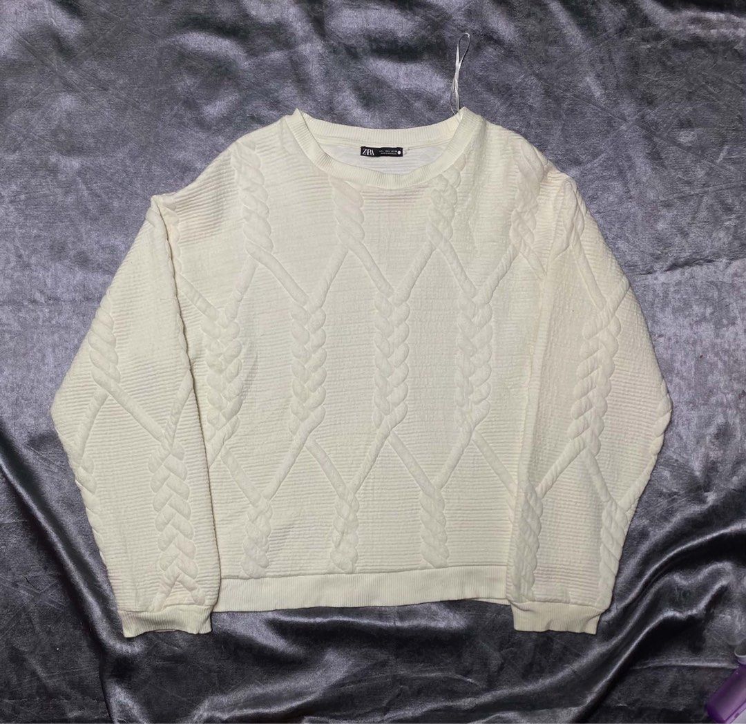 Zara Cable Knit Sweater Off White Size L (Category: Longsleeves) located in Cavite. Submitted by bellewii (Listing ID 1469680807, Image 1). Description: - Brand: Zara - Color: Off-white - Size: L - Style: Crew neck cable knit pullover - Details: Textured pattern on front and sleeves, ribbed collar, cuffs, and hem - Origin: Made in Morocco - Condition: Soft and comfortable for everyday wear.