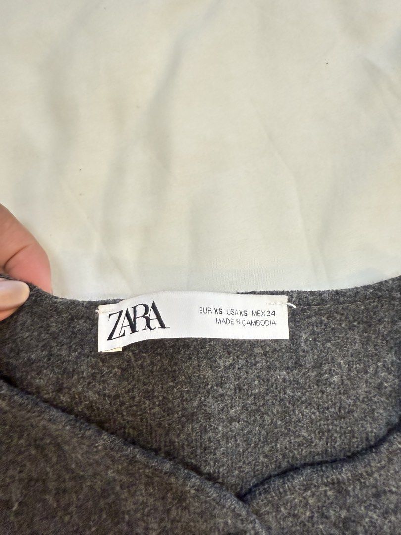 Zara Grey Cardigan Size XS (Category: Coats, Jackets and Outerwear) located in Cebu City. Submitted by marjdeclutter (Listing ID 1469655730, Image 2). Description: - Brand: Zara - Color: Dark grey - Size: XS (fits true to size) - Material: Soft textured wool blend - Details: Unique irregular silver front buttons, crew neckline, long sleeves, cropped fit - Condition: Worn once for a quick photo, practically untouched - Perfect layering piece for c