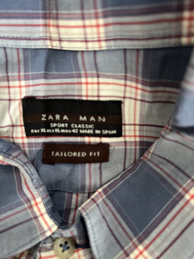 Zara Man Plaid Button-Down Shirt Tailored Fit (Category: Tshirts & Polo Shirts ) located in Muntinlupa City. Submitted by 09leah77 (Listing ID 1469602869, Image 2). Description: - Brand: Zara Man - Style: Plaid button-down shirt with classic button front and chest pocket - Pattern: Blue, white, and red check - Fit: Tailored fit silhouette - Size: XL (Mex 42) - Origin: Made in Spain - Condition: Great casual piece for everyday wear.