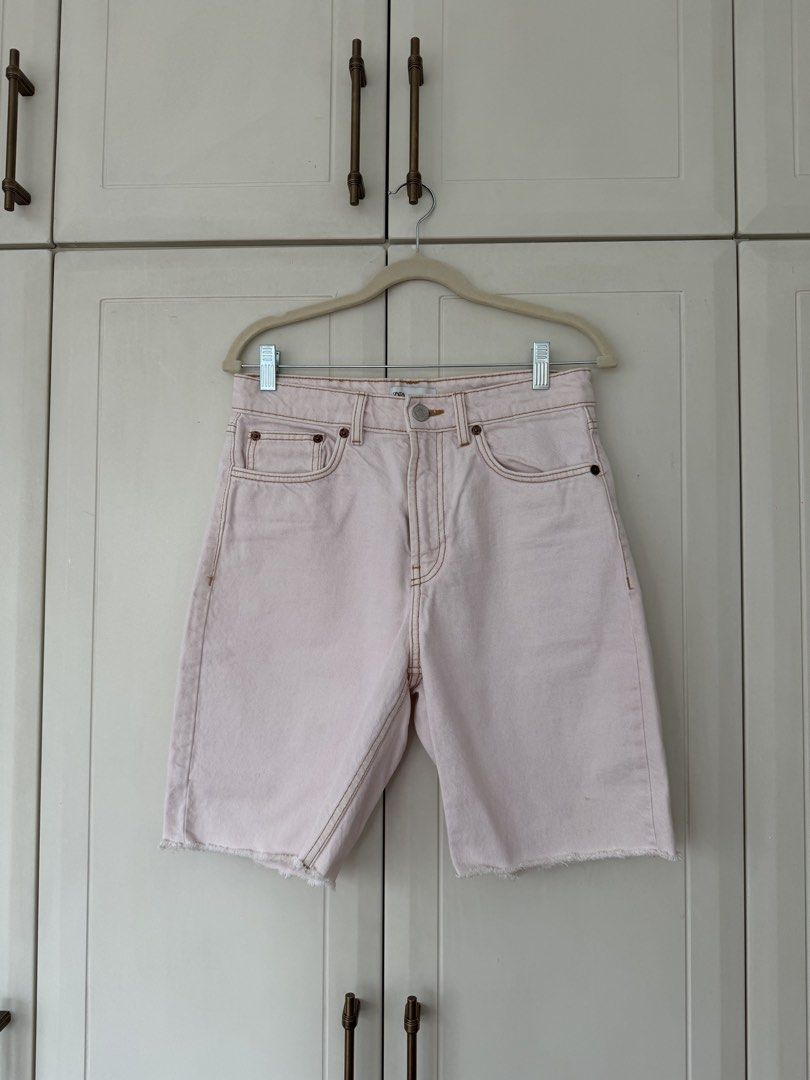 Zara Pink Denim Bermuda Shorts (Category: Shorts) located in Makati City. Submitted by belizalde4 (Listing ID 1469655352, Image 1). Description: - Brand: Zara - Style: Denim shorts with raw hem finish at the knees and contrast stitching - Color: Light pink - Details: Button fly, five-pocket style, leather patch on back waistband - Size: EUR 38, USA 6, MEX 28 - Condition: good.