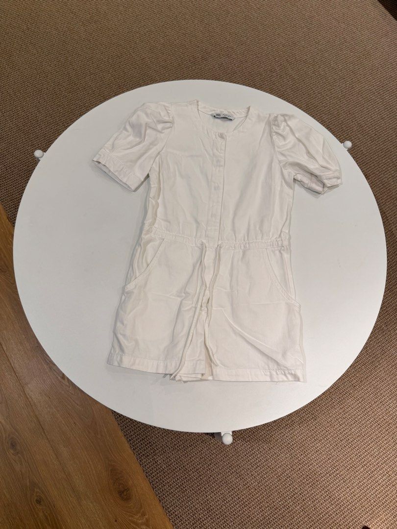Zara White Puff Sleeve Romper Size S (Category: Rompers) located in Muntinlupa City. Submitted by henlo03 (Listing ID 1469610064, Image 2). Description: - Brand: Zara - Style: White romper - Size: S - Features: Short puff sleeves, round neckline, snap button front closure - Waist: Elasticized with adjustable drawstring detail - Pockets: Functional side pockets included - Origin: Made in Turkey - Condition: Clean, crisp white fabric, ready to wear