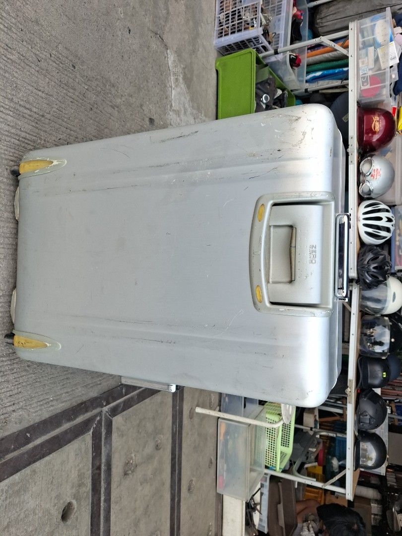 Zero Halliburton Silver Rolling Suitcase (Category: Luggage) located in Manila. Submitted by rocksolid227 (Listing ID 1469628759, Image 2). Description: - Brand: Zero Halliburton - Color/Material: Silver hardside metal build - Features: Secure latch closure, top handle, and smooth rolling wheels - Condition: Heavy travel wear with visible surface scuffs, scratches, and marks throughout the exterior shell - Perfect for frequent flyers looking for 
