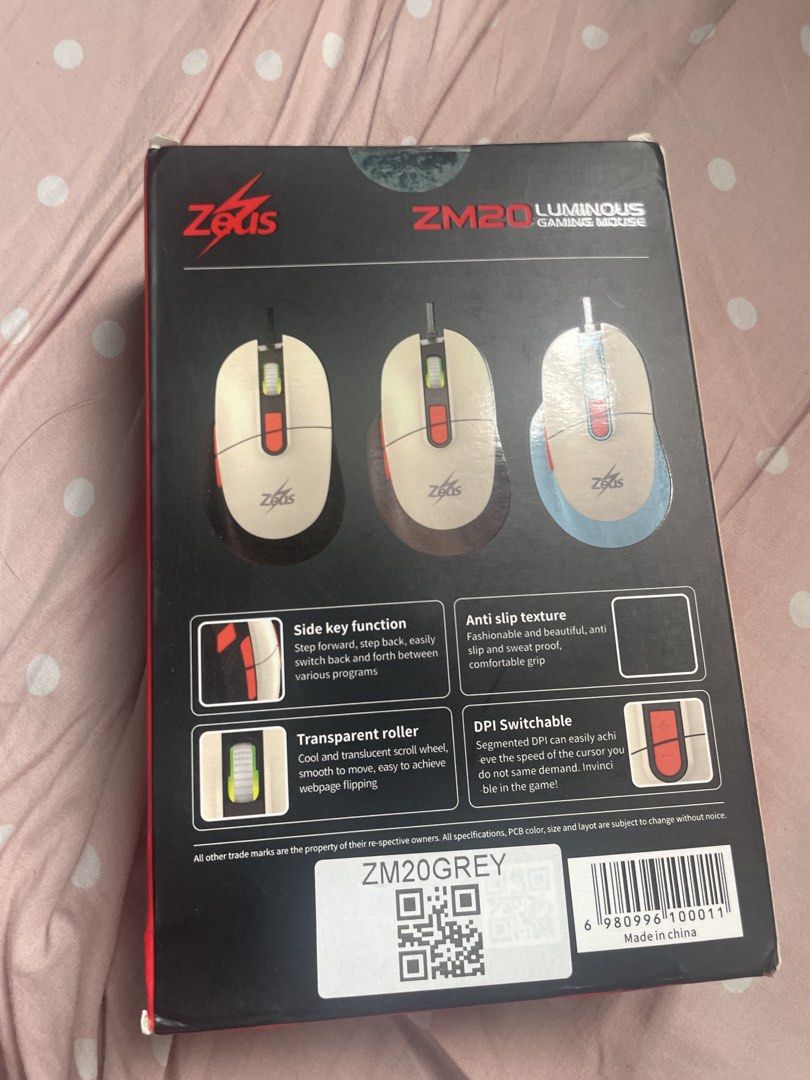 Zeus ZM20 Luminous Gaming Mouse (Category: Mouse & Mousepads) located in Manila. Submitted by cchicchen (Listing ID 1469596901, Image 2). Description: - Model: Zeus ZM20 Luminous Gaming Mouse - Design: White body with dark accents - Connectivity: Wired - Features: Scroll wheel, extra top and side buttons - Condition: Good, ideal for budget gaming setups - Packaging: Original box included (minor wear on corners).
