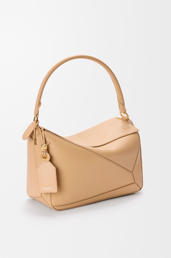 💜 Loewe Medium Featherlight Puzzle bag in nappa lambskin (Category: Luxury Bags & Wallets) located in Lala. Submitted by mohsin0825 (Listing ID 1469814325, Image 1). Description: Loewe Medium Featherlight Puzzle bag in nappa lambskin 17,990 plus sf Like new/Brand-new Cream textured-leather (Lamb) Top handle, detachable adjustable shoulder strap External zipped pocket, internal slip pocket Fully lined Zip fastening along top Comes with a dust bag