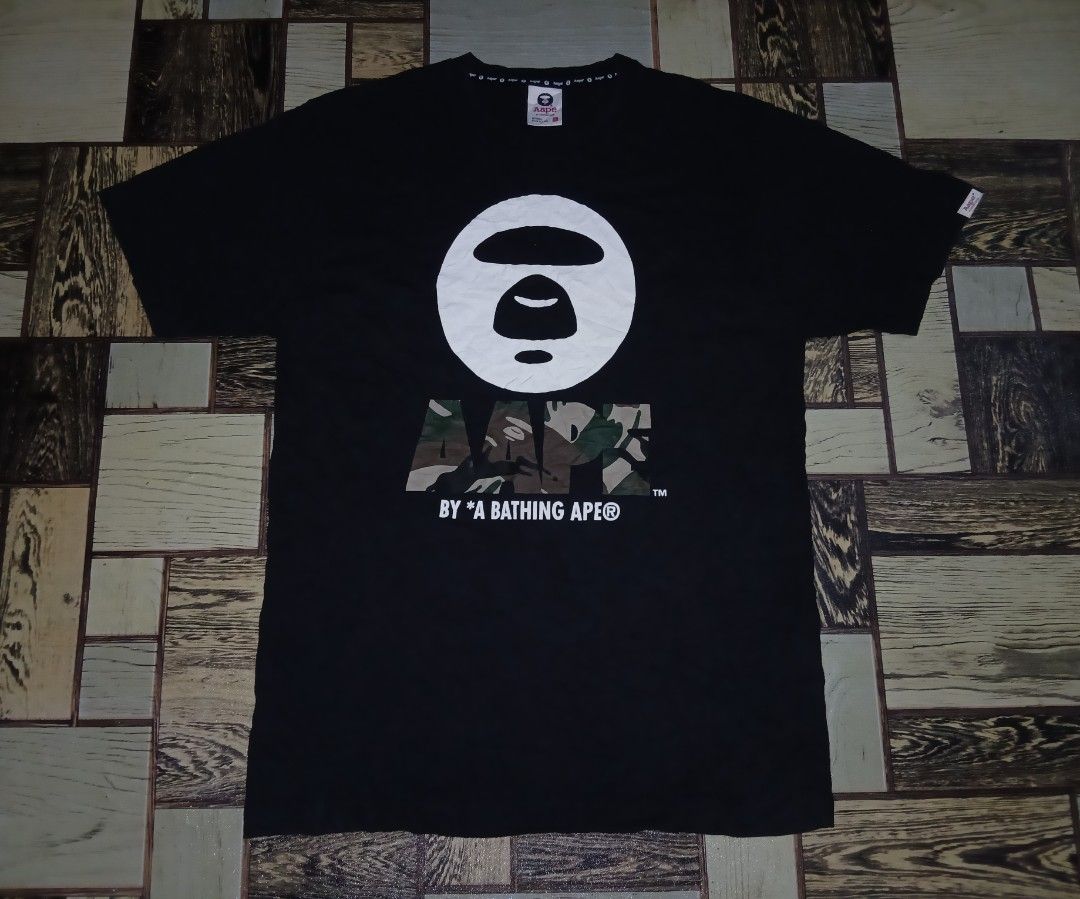 AAPE By A Bathing Ape Black Camo Tee Size L (Category: Tshirts & Polo Shirts ) located in Caloocan City. Submitted by youngmoon_51e2c6 (Listing ID 1469804029, Image 1). Description: - Brand: AAPE By A Bathing Ape - Color: Black - Size: Large (L) - Design: Large white Ape head graphic with camo fill and branding - Details: Branded neck tape, solid cotton build - Condition: Great streetwear piece, ready to wear.
