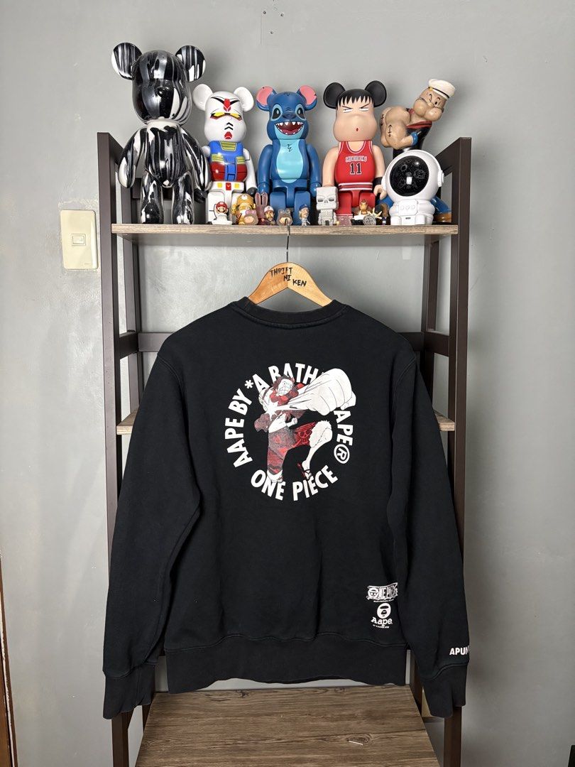 AAPE x One Piece Black Sweatshirt Size S (Category: Coats, Jackets and Outerwear) located in Manila. Submitted by thriftnikenv.2 (Listing ID 1469865280, Image 2). Description: - Brand: AAPE by A Bathing Ape x One Piece - Item: Black Crewneck Sweatshirt - Size: Small - Design: Luffy skull logo on chest, large graphic on back, branded sleeve and collar details - Material: Comfortable cotton and polyester blend - Condition: Brand new / Excellent - M