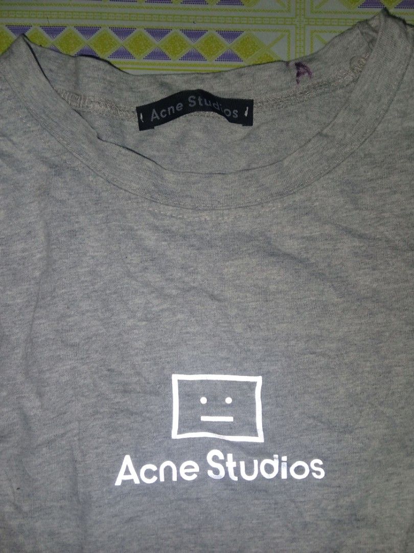 Acne Studios Grey Face Logo T-shirt (Category: Tshirts & Polo Shirts ) located in Koronadal. Submitted by daily_garment (Listing ID 1469889770, Image 2). Description: - Brand: Acne Studios - Color: Grey Heather - Size: XL (Casual Oversized Fit) - Material: 100% Cotton, Made in Portugal - Design: Classic face logo graphic on chest - Details: Standard crew neckline, short sleeves, with complete interior brand and wash tags (DIMENSIONS) WIDTH 21 LEN