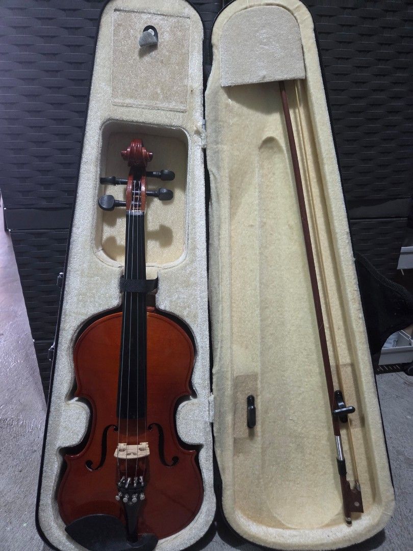 Acoustic Violin with Hard Case and Bow (Category: Musical Instruments) located in Muntinlupa City. Submitted by lou_ao (Listing ID 1469788402, Image 1). Description: - Instrument: Acoustic violin with a natural wood finish - Hardware: Standard pegs, bridge, tailpiece, and chinrest - Included: Matching bow and durable padded hard case - Interior: Soft beige fabric lining for extra protection - Condition: Stored safely in its zip case, ready for pr
