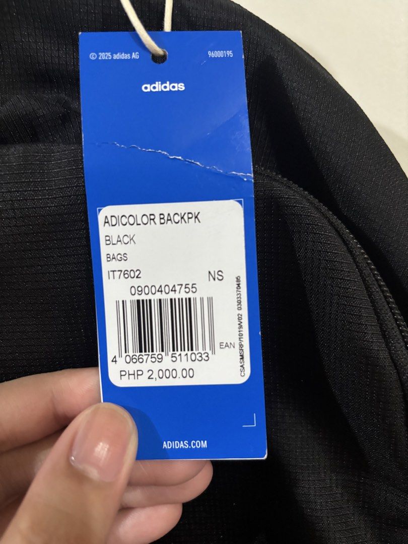 Adidas Adicolor Backpack Black (Category: Backpacks) located in Manila. Submitted by karinaaaaaaa2000 (Listing ID 1469777529, Image 2). Description: - Brand: Adidas - Model: Adicolor Backpack (Style: IT7602) - Color: Black with large white trefoil logo - Condition: Brand new with original store tags - Retail Price: PHP 2,000.00 - Features: Zip closure, top carry handle, adjustable mesh shoulder straps, and interior slip pocket with Adidas logo pa