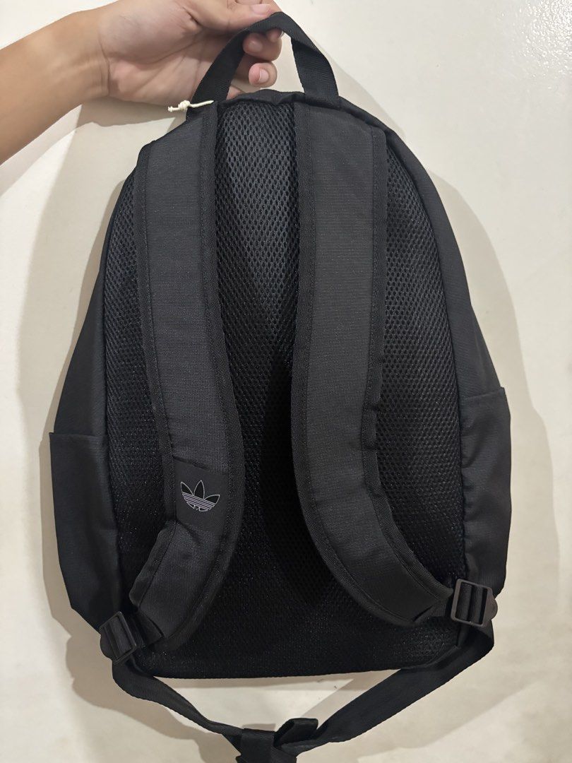 Adidas Adicolor Backpack Black (Category: Backpacks) located in Manila. Submitted by karinaaaaaaa2000 (Listing ID 1469777529, Image 3). Description: - Brand: Adidas - Model: Adicolor Backpack (Style: IT7602) - Color: Black with large white trefoil logo - Condition: Brand new with original store tags - Retail Price: PHP 2,000.00 - Features: Zip closure, top carry handle, adjustable mesh shoulder straps, and interior slip pocket with Adidas logo pa