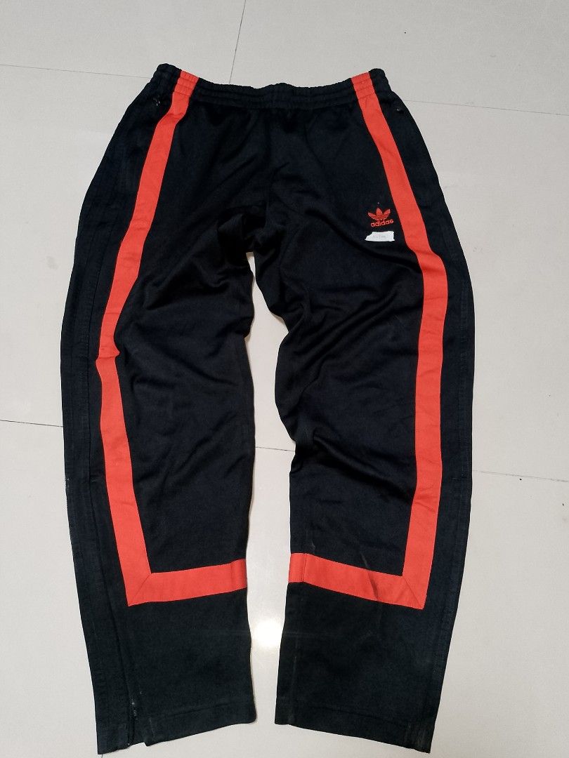 Adidas Black Orange Track Pants (Category: Joggers) located in Manila. Submitted by mjthrifted_second (Listing ID 1469829132, Image 1). Description: Code 2 - Brand: Adidas - Style: Track pants - Size: M - Color: Black with bold orange stripe panels on lower legs - Details: Classic embroidered trefoil logo near left pocket, zippered side pockets, elastic waistband with adjustable drawstring - Condition: Clean, solid fabric with no major flaws - Pe