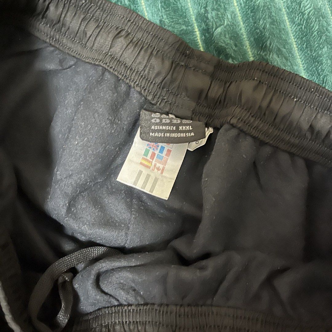 Adidas Black Track Pants (Category: Joggers) located in Manila. Submitted by thriftkolngeh (Listing ID 1469935015, Image 3). Description: - Brand: Adidas - Color: Black with silver logo and reflective three stripes - Size: Asian XXXL - Country of Origin: Made in Indonesia - Features: Elastic waistband with drawstring, cozy inner lining for extra warmth - Condition/Use: Great for workouts or casual streetwear pm sa ibang dets tinamad nko palitan e