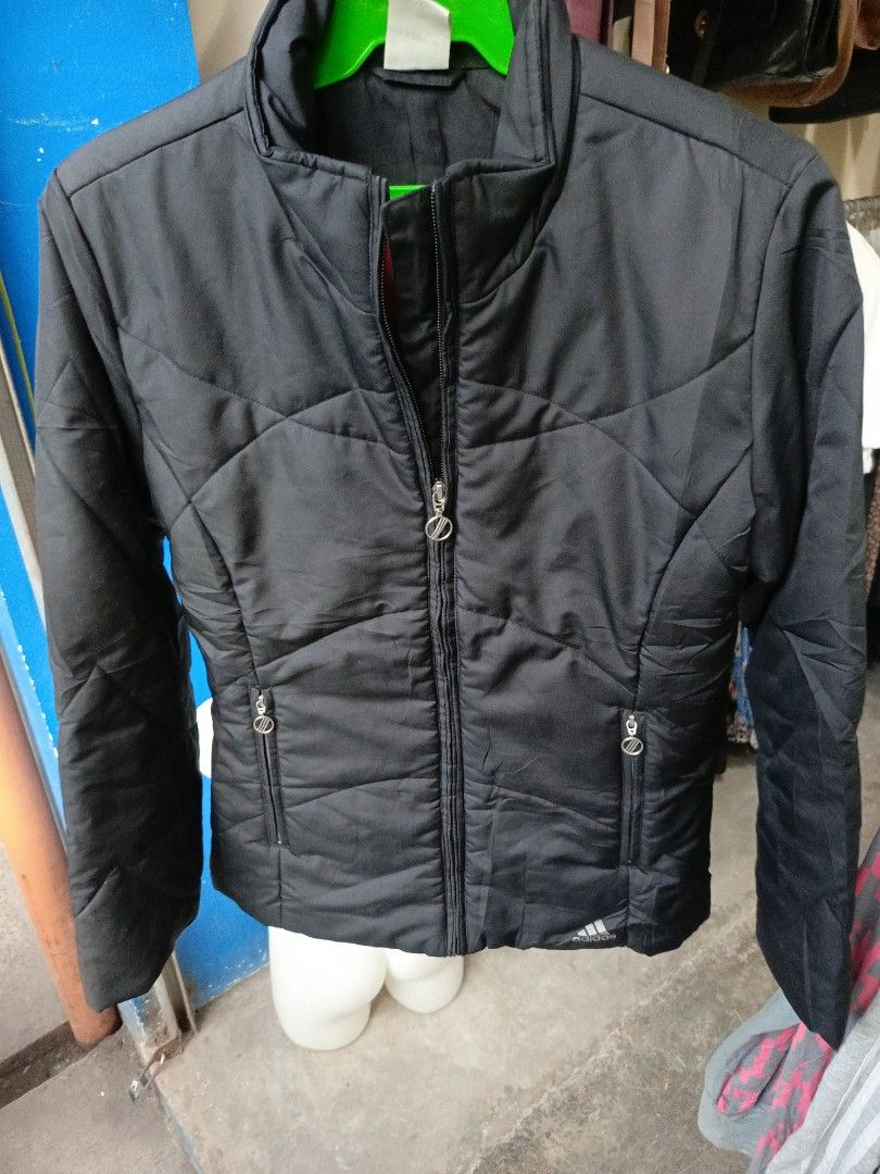 Adidas Black Winter Puffer Jacket Size S (Category: Coats, Jackets and Outerwear) located in Cabatuan. Submitted by penthegreat (Listing ID 1469888146, Image 1). Description: - Brand: Adidas - Style: Puffer jacket with full zip front and stand-up collar - Color: Black exterior with a vibrant bright red inner lining - Size: S (Tag: 160/84A) - Pockets: Secure zippered pockets on both sides - Details: Subtle Adidas logo near the bottom hem and debos